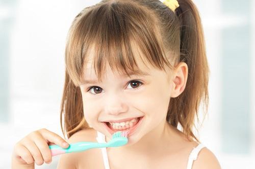 Toddler brushing her teeth at dentist near me Towson MD