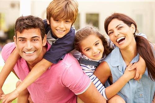 Family smiling outside of dentist office in Towson MD
