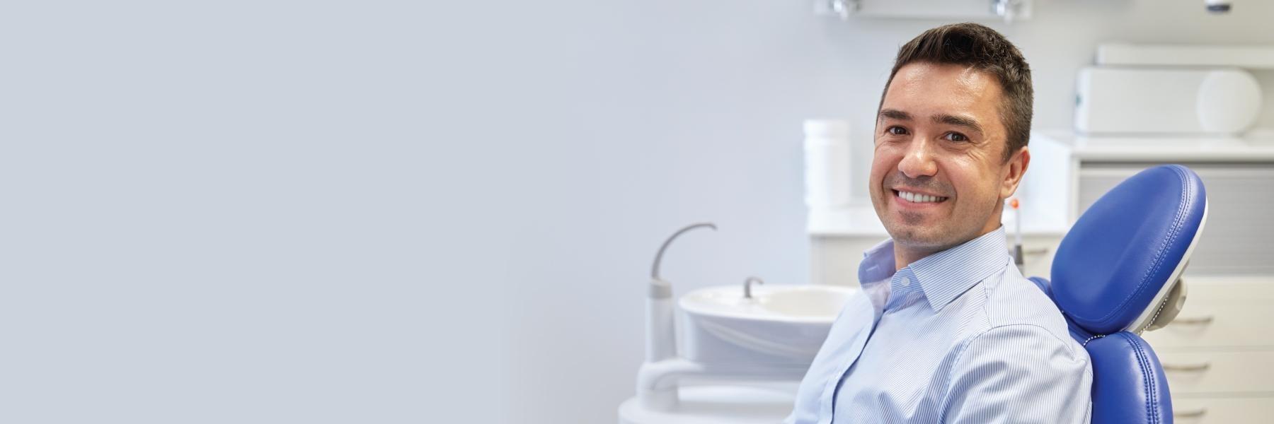 Patient sitting in treatment chair at dentist in Towson, MD