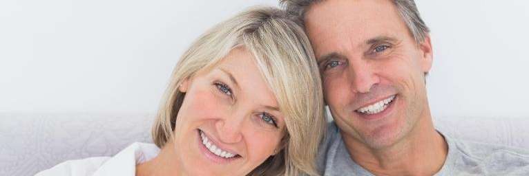 Couple smiling at dentist office in Towson, MD