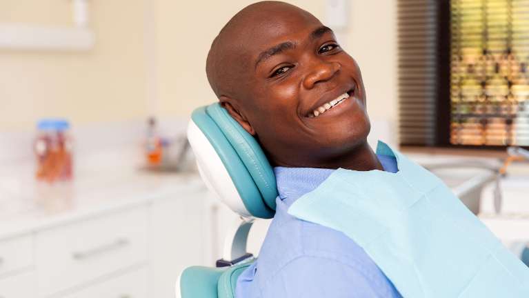 Man smiling in treatment chair at root canal dentist in Towson, MD