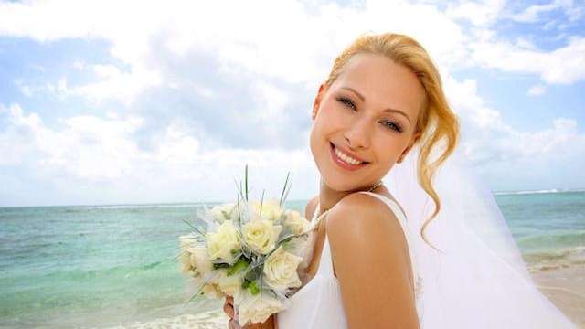 Bride smiling on a beach in Towson, MD