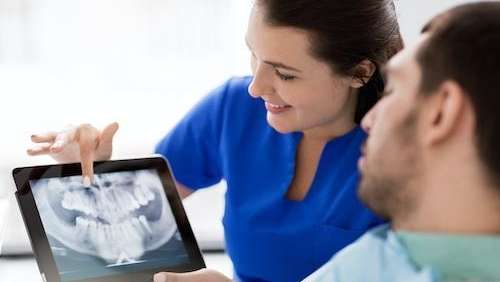 Dentist in Towson, MD showing patient an x-ray scan