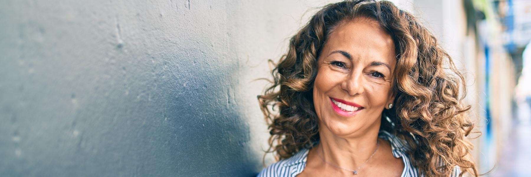 Woman with tooth implants smiling in Towson, MD