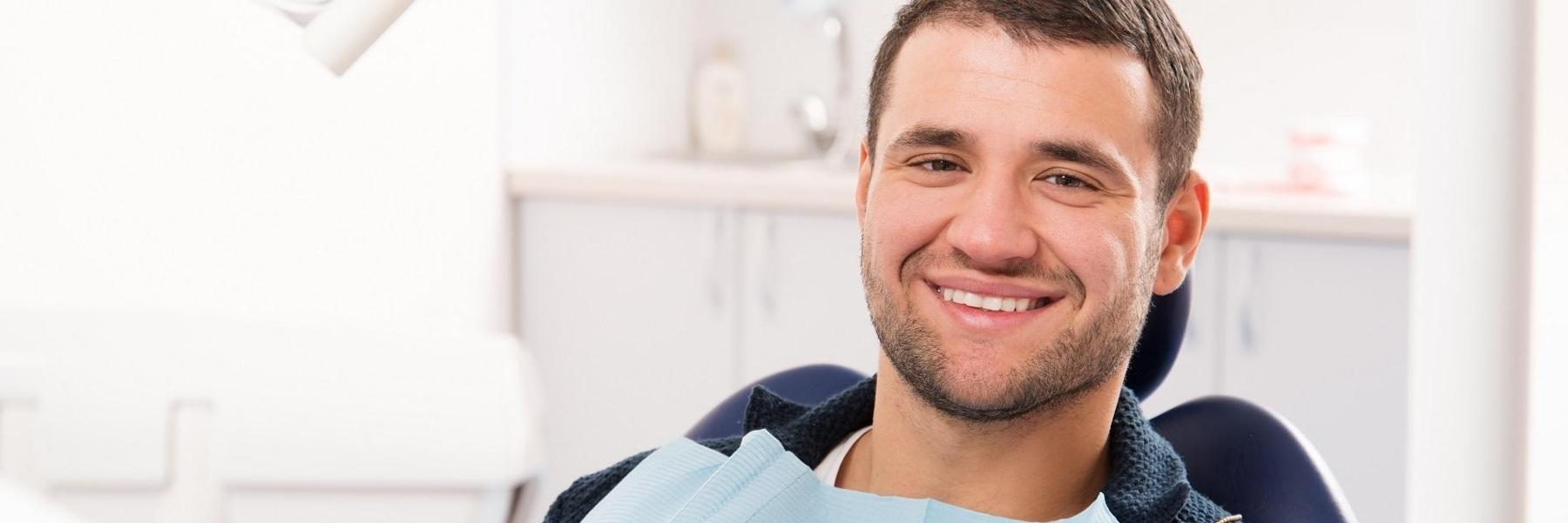 Patient smiling in chair at dentist in Towson MD